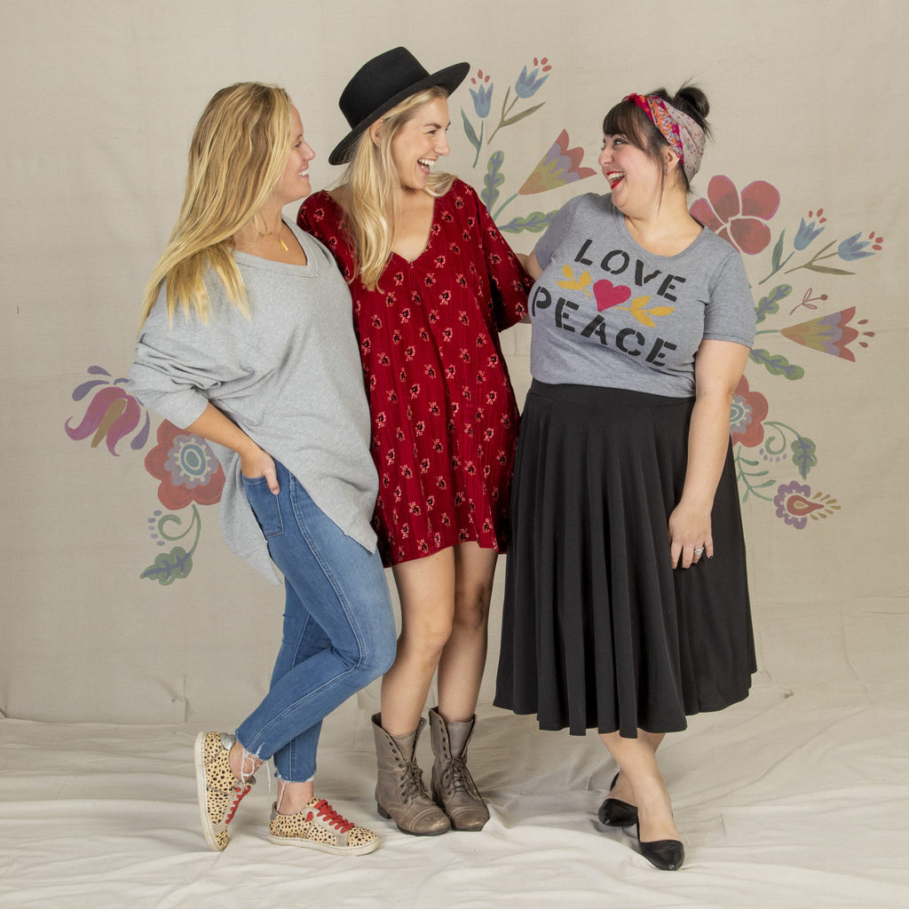 Three girls wearing cute clothes laughing