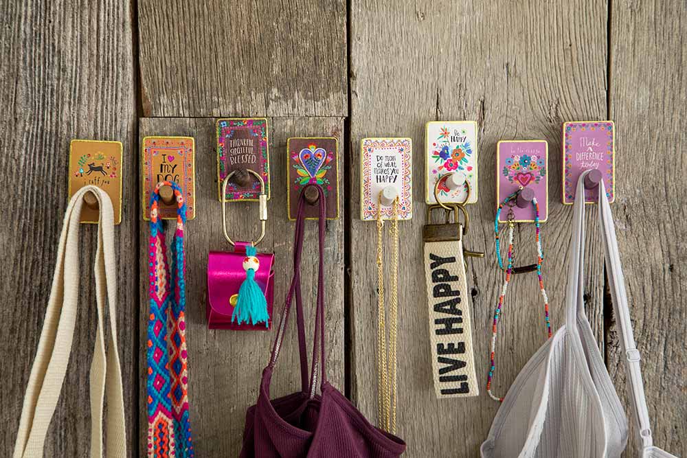 Photo of wooden wall hooks with things hanging from them