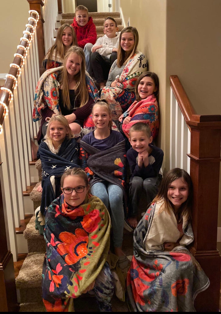 Girls wrapped in cozy tapestry blankets