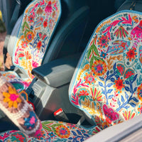 Colorful floral-patterned car seat covers in a vehicle.