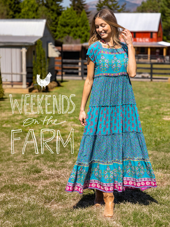Woman in a blue dress standing on a farm with text 'Weekends on the Farm'.