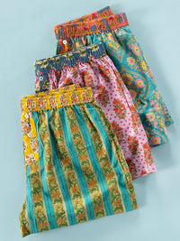Stack of colorful patterned boxers on a light blue background