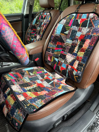image of a patchwork seat protector in a car with a steering wheel cover