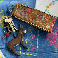 embroidered keychain and keychain with donkey on patterned background