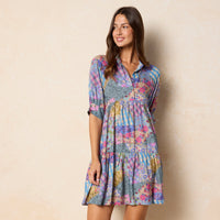 girl in a blue patchwork gingham mini dress