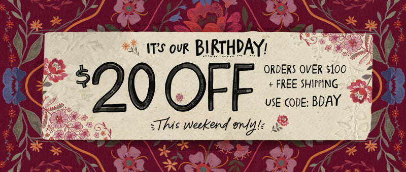 A promotional birthday sale banner with a cream central panel reading 'IT'S OUR BIRTHDAY! $20 OFF' and 'This weekend only!' on a dark floral patterned background.
