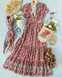 Floral dress with accessories on a light blue background
